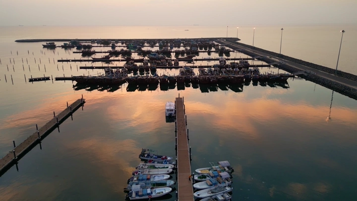 سفن راسية في ميناء جازان عند الغروب، تصوير درون.