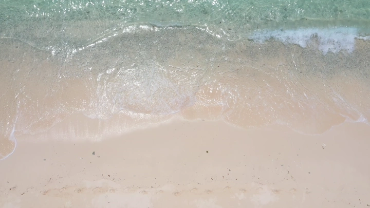 A sandy beach and sea waves in the Asir region, aerial shot.