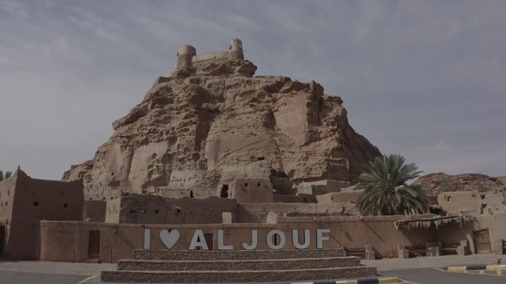 Za'abal Castle in Sakaka under cloudy sky, wide shot.