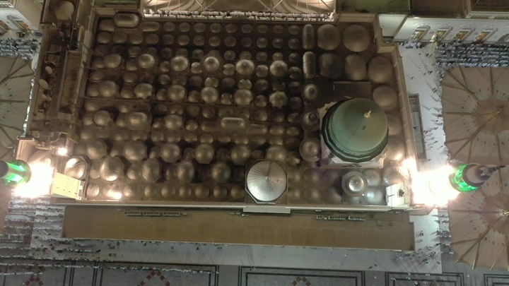 An aerial view of the Prophet's Mosque in Medina at night.