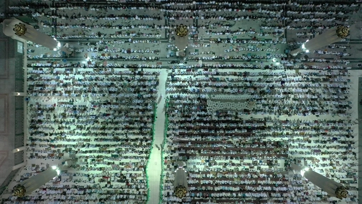 Congregational prayer at Al-Masjid an-Nabawi in Medina, aerial shot.