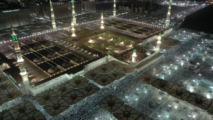 Prophet's Mosque in Medina at night, aerial shot.