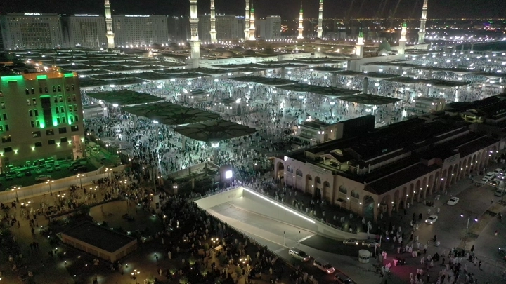 Prophet's Mosque in Medina at night, aerial shot.