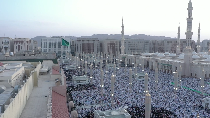Al-Masjid an-Nabawi in Medina at sunset, aerial shot.