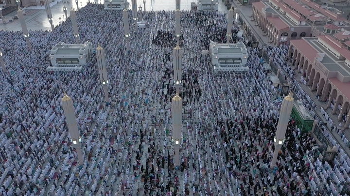 Prophet's Mosque in Medina during prayer, aerial shot.