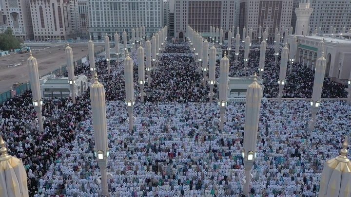 Congregational prayer at Al-Masjid an-Nabawi in Medina, aerial shot.