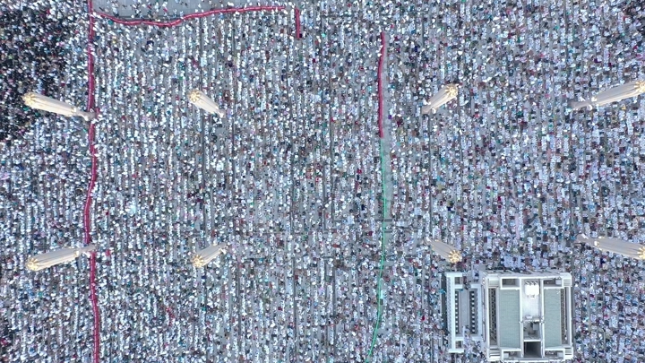 Aerial view of Al-Masjid an-Nabawi in Medina during prayer, drone shot.