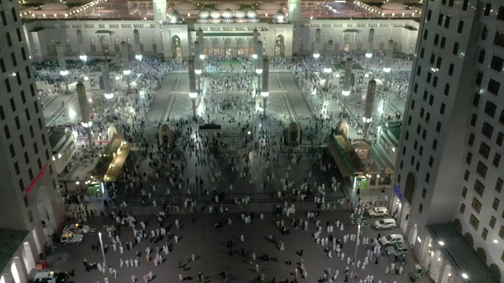 Al-Masjid an-Nabawi in Medina at night, aerial shot.