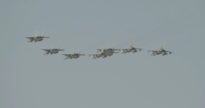 Formation of jets in an air show, clear sky, ground shot.