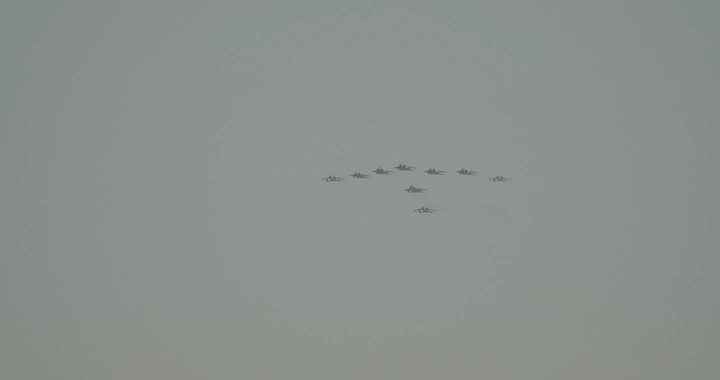 Aircraft formation in an air show for National Day, distant shot.