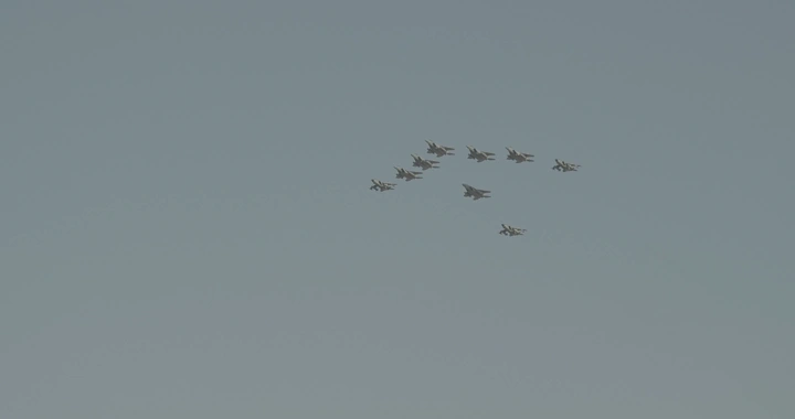 Aircraft formation in the sky during air show, wide shot.