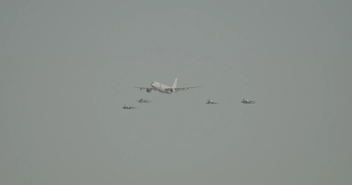 Aircraft formation in National Day airshow, distant shot.