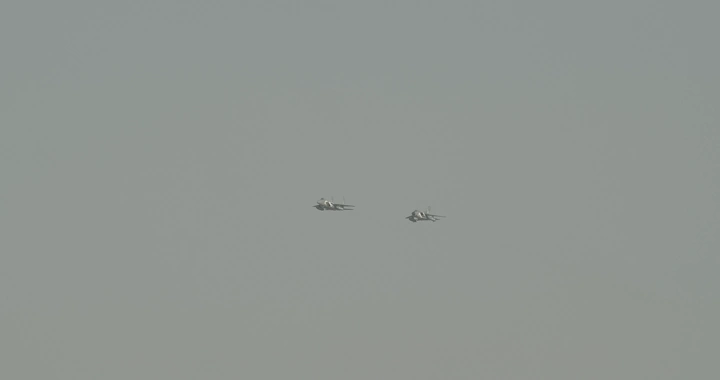 Two planes in an air show in the sky, distant shot.