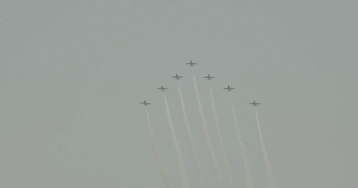 Planes flying in formation during National Day, ground shot.