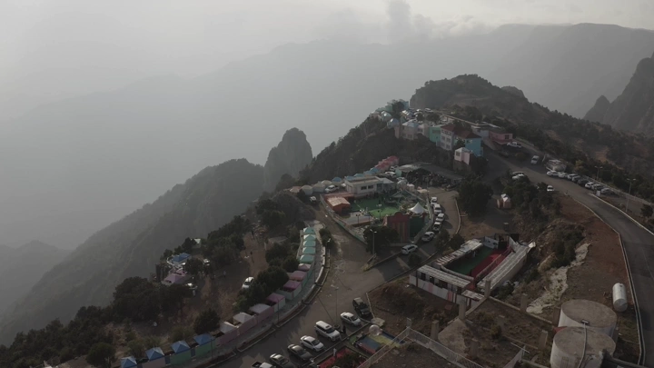 Aerial view of Al-Sahab Park in Abha under a cloudy sky.