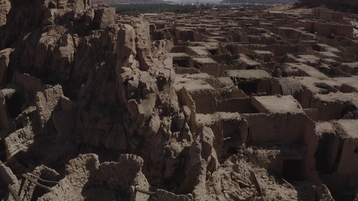 Aerial view of the old town of AlUla, showing clustered mudbrick buildings.