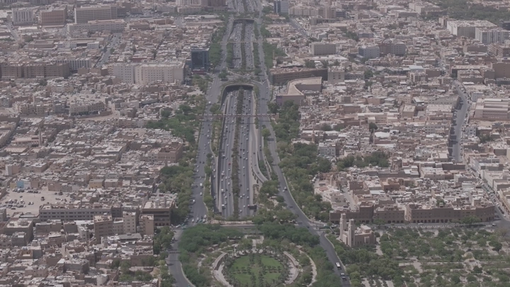 Aerial shot of Riyadh city and King Fahd Road Park, drone photography.