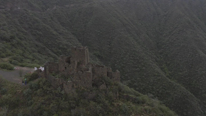 An ancient stone castle in Rijal Alma in the Asir region, aerial shot.
