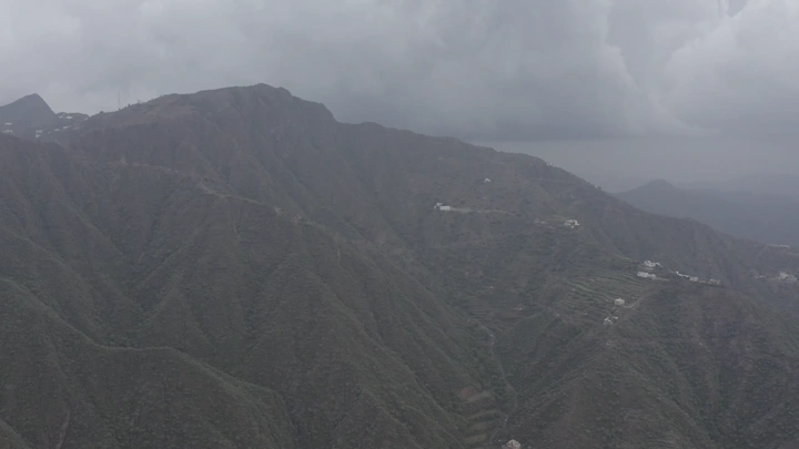 Mountains of Rijal Almaa in Asir region, aerial shot on a cloudy day.