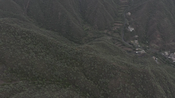 Aerial shot of green mountains in Rijal Alma, Asir region, drone photography.