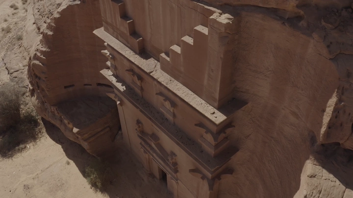 An aerial shot of the archaeological site of Al-Hijr, Madain Salih in Al-Ula, taken during the day.