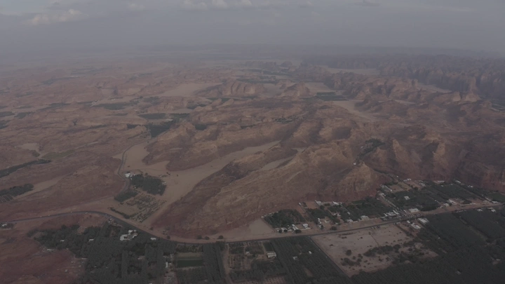 Mountains and farms of AlUla from above on a cloudy day, aerial shot.