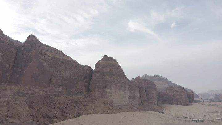 AlUla mountains under a cloudy sky, wide shot.