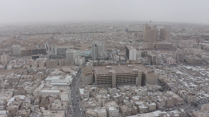 Aerial view of Riyadh neighborhoods on a cloudy day, drone shot.