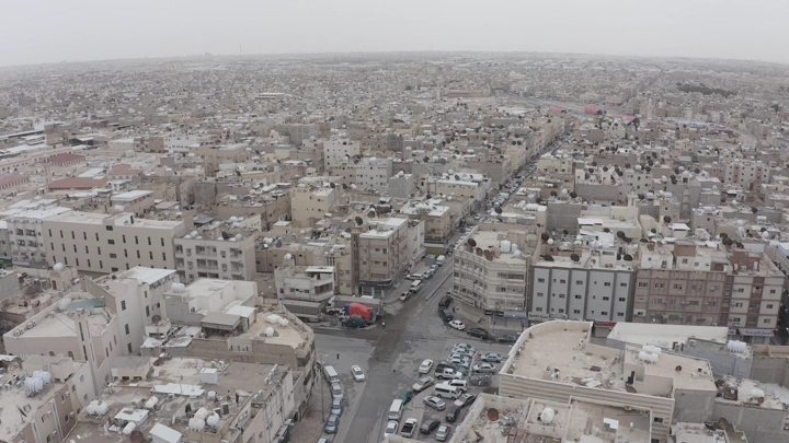 Aerial view of the neighborhoods of Riyadh on a cloudy day, shot from a drone.