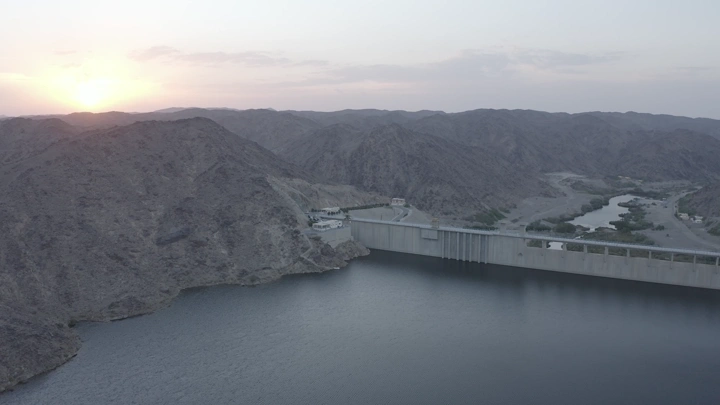 Bisha Valley Dam in Asir region at sunset, aerial shot.