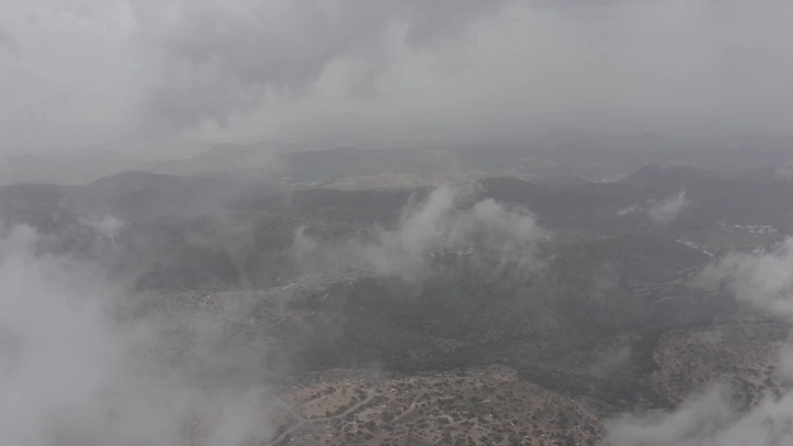 Aerial view of the Al-Soudah Mountains in Asir under the clouds, aerial shot.