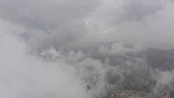 Al-Soudah mountains covered in clouds, Asir region, aerial shot.