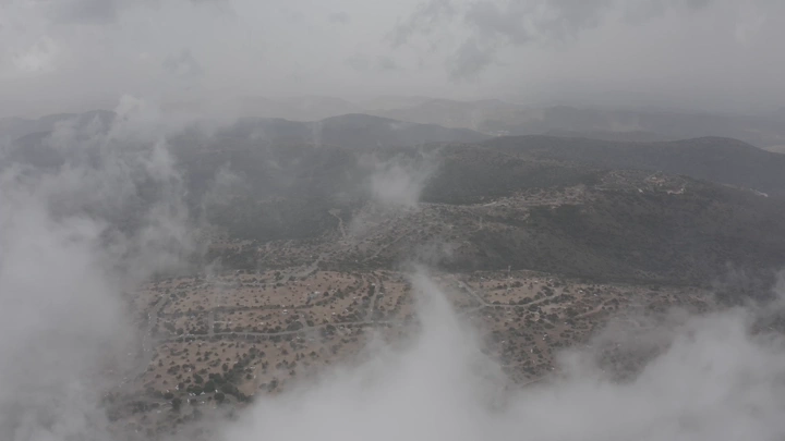 Aerial view of the Al-Soudah Mountains in Asir among the clouds, an aerial shot.