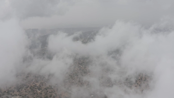 Al-Soudah mountains covered in clouds, Asir region, aerial shot.