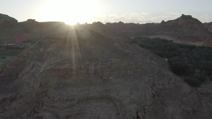 Mountains and farms of AlUla at sunset, aerial shot.