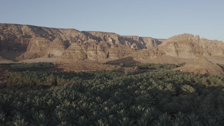 Mountains and farms in AlUla during daylight, aerial shot.