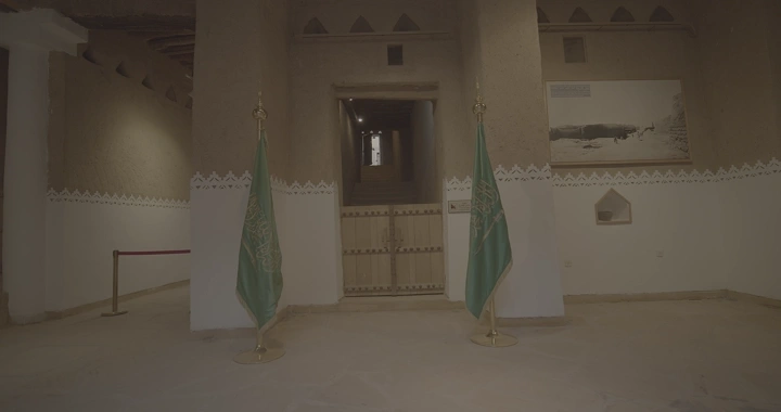 مدخل قصر المصمك بالرياض مع علمين سعوديين، لقطة داخلية.