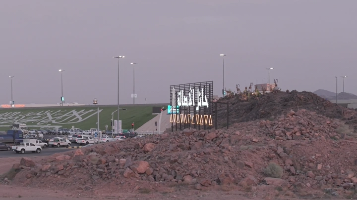 Aerial view of Hail city at sunset, featuring a welcome sign.
