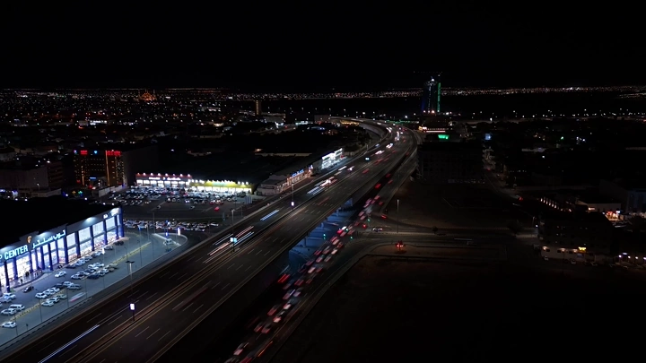 Illuminated roads and bridges in Hail city at night, drone shot.