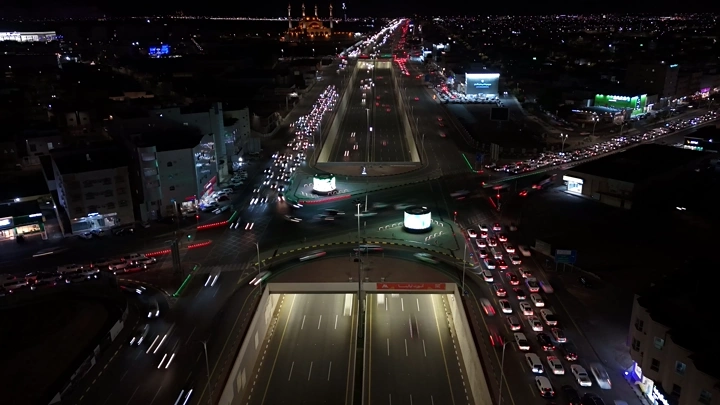 Illuminated roads and bridges at night in Hail, drone shot.