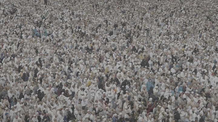 Large crowd of people in white clothing at the Haram, aerial shot.
