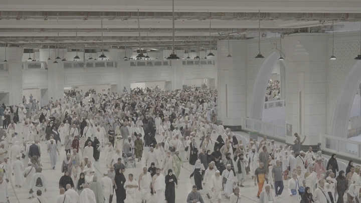 Crowds of people in the Grand Mosque, wide shot.
