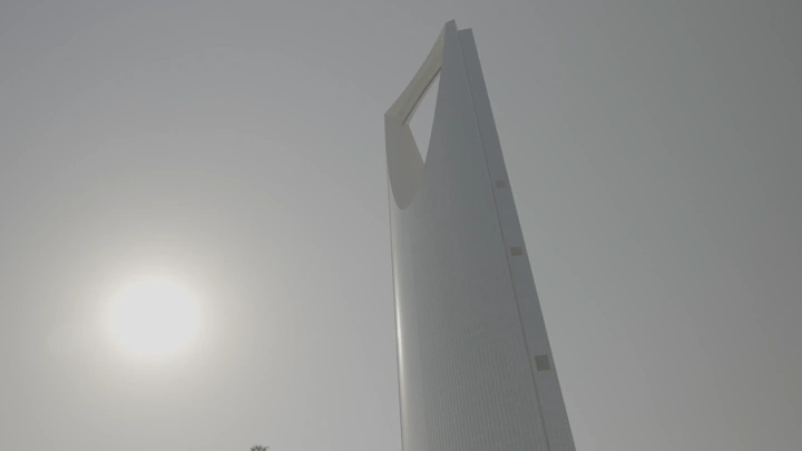 Tall tower in Riyadh under the sun, low-angle shot.