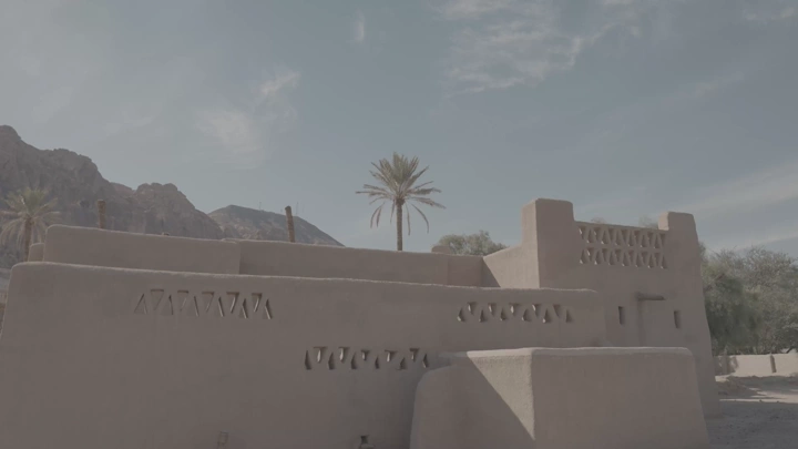 مبنى طيني تقليدي في العلا تحت سماء صافية، لقطة نهارية.