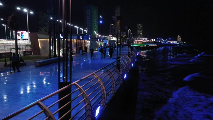 ممشى مضاء ليلاً على كورنيش جدة، تصوير ليلي.