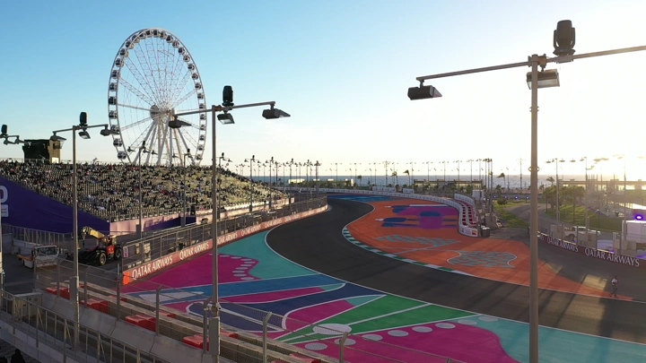 Colorful race track in Jeddah with Ferris wheel, daytime shot.