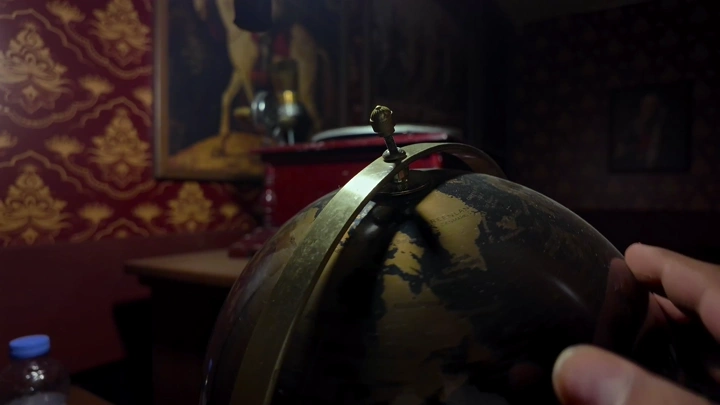 Globe in a classic decor room, close-up shot.