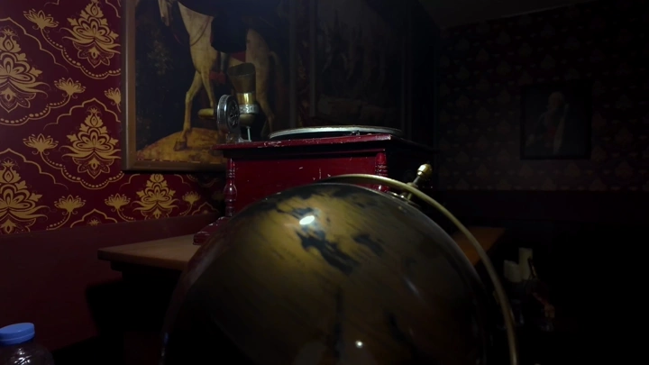 Globe on a table in a dimly lit room, indoor shot.