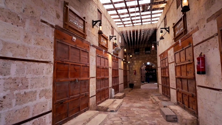 A corridor in an old market with wooden doors in Yanbu, interior shot.