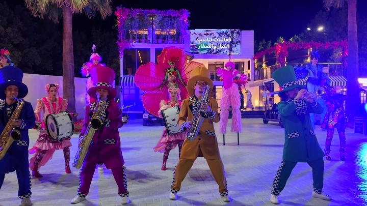Clowns playing music at a party during the Flower Festival in Yanbu Industrial City, night photography.